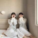 パジャマを着て、手でマルをしている2人の女性